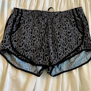 Black and white Calvin Klein logo running shorts.